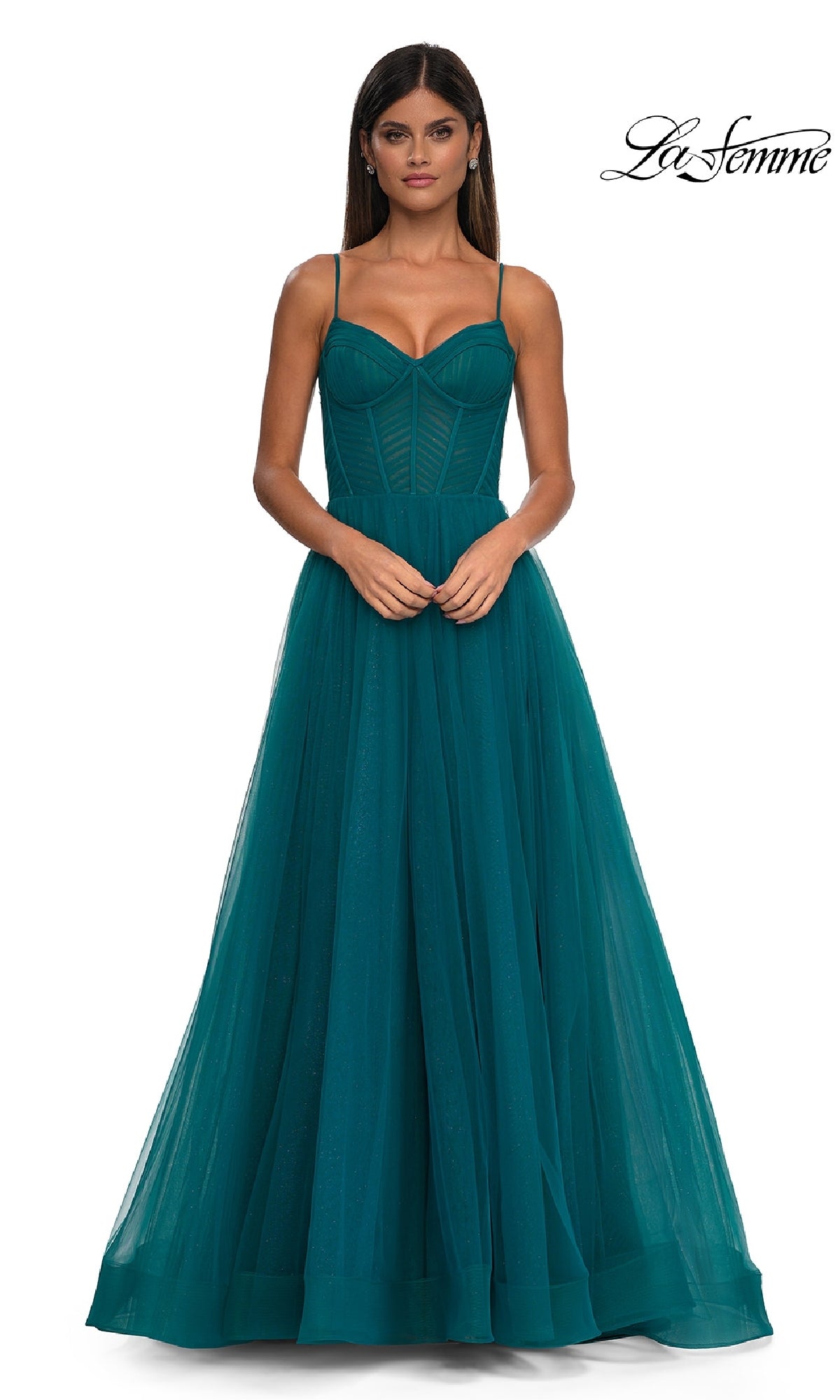 A woman in a teal, floor-length, sleeveless Long Corset A-Line Prom Dress (La Femme 32680) with a fitted bodice and tulle skirt stands facing forward. The La Femme logo appears in the top right corner.